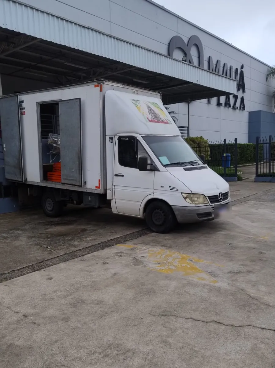Caminhão baú com as portas abertas durante uma entrega